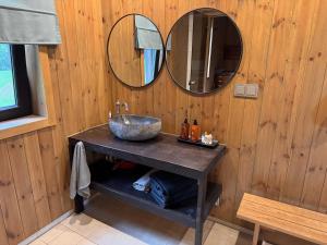 a bathroom with a sink and a mirror at Sunset puhkemaja in Kaigutsi