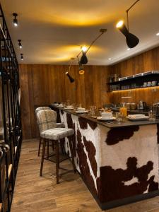 a bar in a restaurant with a cow pattern at Le Mallet, Courmayeur, Alpine Homesuite in Courmayeur