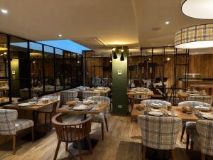 a restaurant with wooden tables and chairs in a room at Le Mallet, Courmayeur, Alpine Homesuite in Courmayeur