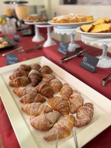 a tray of donuts and pastries on a table at Hotel Simon in Gatteo a Mare
