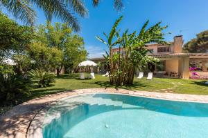 a swimming pool in front of a house at Villa Reginella - Rive del Salento in Lecce