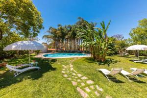 a yard with two chairs and a swimming pool at Villa Reginella - Rive del Salento in Lecce