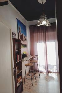 a dining room with a table and chairs and a chandelier at Nonno Turiddu Elegant Rooms in Caccamo
