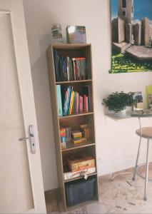 a book shelf filled with books next to a table at Nonno Turiddu Elegant Rooms in Caccamo