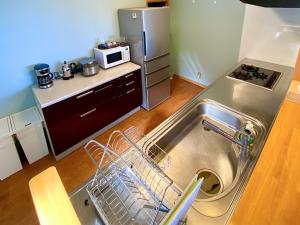 a small kitchen with a sink and a refrigerator at Nonoya - Vacation STAY 78469v in Goto +16 photos