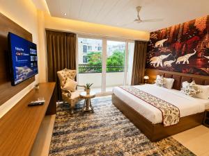 a hotel room with a bed and a large window at Jalsa Heritage- A Boutique Hotel in Jaipur
