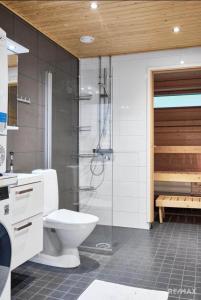 a bathroom with a toilet and a shower in it at Modern two-bedroom apartment in Espoo +2 photos