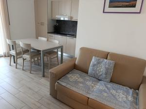 a living room with a couch and a table at Alma di Alghero Apartments in Alghero