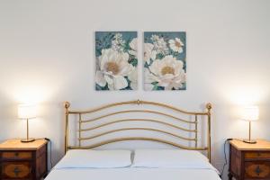 a bedroom with a bed with two night stands and two lamps at I Vacanzieri in Catania +35 photos