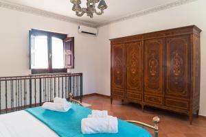 a bedroom with a bed and a large wooden cabinet at I Vacanzieri in Catania