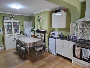 a kitchen with a table and a table and chairs at Castle Room in Windsor +7 photos