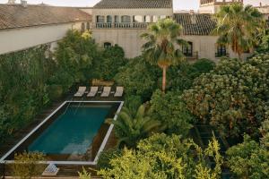 an overhead view of a swimming pool in front of a building at Hospes Palacio del Bailio, a Member of Design Hotels in Córdoba