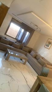 a living room with a couch and a window at Nador hola corniche in Nador