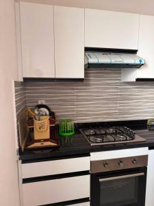 a kitchen with white cabinets and a stove top oven at Nador hola corniche in Nador