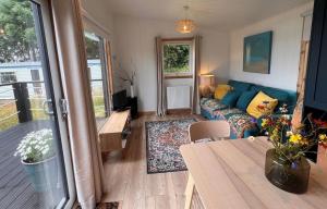 a living room with a couch and a table at Tiny Mara in Uig