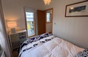 a bedroom with a bed and a window at Tiny Mara in Uig
