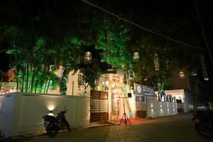 a motorcycle parked in front of a building at night at Sarovar Palace in Prayagraj