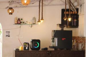 a kitchen with a coffee machine on a table at Sarovar Palace in Prayagraj