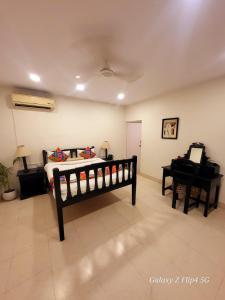 a bedroom with a bed and a piano at Sarovar Palace in Prayagraj +22 photos