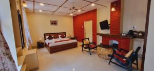 a bedroom with a bed and a fireplace at Sarovar Palace in Prayagraj