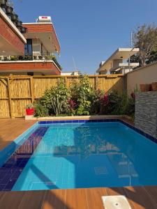 a swimming pool in the backyard of a house at Roses Villa at Elysium Home in Dodoma