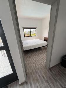 a small room with a bed and a window at VR Villa in Trou d'Eau Douce
