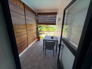 a room with a table and a chair and a window at VR Villa in Trou d'Eau Douce