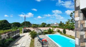 a view of a swimming pool from the balcony of a house at VR Villa in Trou d'Eau Douce