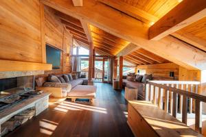 a living room with wooden walls and ceilings with a fireplace at Chalet Namapa in Saint-Martin-de-Belleville