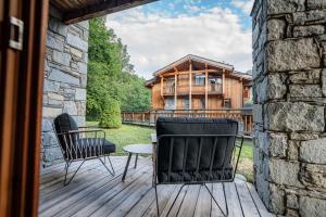 a house with two chairs and a table on a deck at Chalet Namapa in Saint-Martin-de-Belleville