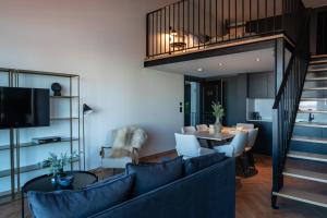 a living room with a couch and a dining room at Nôma Living Avenida 60 in Aveiro
