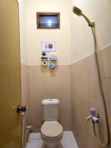 a bathroom with a toilet and a shower at M2 Homestay Jogja in Jarakan