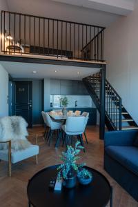 a living room with a blue couch and a table at Nôma Living Avenida 60 in Aveiro