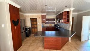 a kitchen with a black counter top in a room at Trendy Tranquility in Secunda