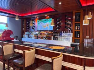 a bar at a restaurant with a person sitting at it at 2RN SOLOMON Hotel and Spa  +8 photos