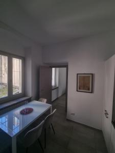 a dining room with a glass table and chairs at Casa moderna in centro storico in Asti