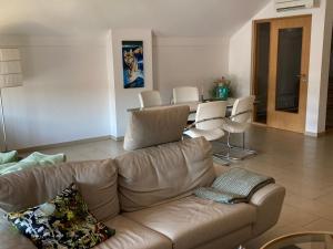 a living room with a couch and a table and chairs at Allegra am Niederrhein in Neukirchen-Vluyn