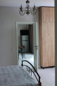 a bedroom with a bed and a door to a dining room at Sunny Home in Ijevan