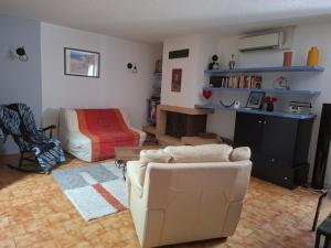 a living room with a couch and a bed at LA BOUVIERE in Aulnat