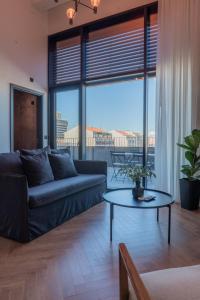a living room with a couch and a table at Nôma Living Avenida 60 in Aveiro