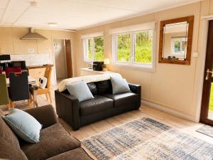 a living room with a couch and a table at John D's Cabin Getaway in Derry Londonderry +2 photos