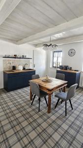 a large kitchen with a wooden table and chairs at Rustic House v Lužických horách in Jiřetín pod Jedlovou