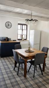 a kitchen with a wooden table and chairs at Rustic House v Lužických horách in Jiřetín pod Jedlovou