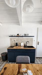 a kitchen with a blue counter and a sink at Rustic House v Lužických horách in Jiřetín pod Jedlovou +13 photos