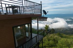 a balcony of a house with a view of the clouds at ฟลายมี ภูทับเบิก in Ban Maeo Thap Boek