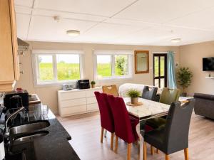 a kitchen and dining room with a table and chairs at John D's Cabin Getaway in Derry Londonderry