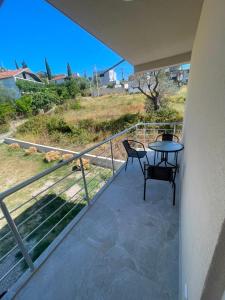 a balcony with a table and chairs on it at Rujovic 