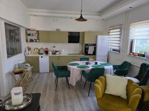 a kitchen with a table and chairs in a room at Riverside Residence Apartment in Travnik
