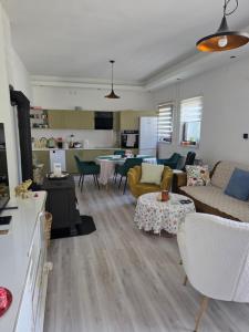 a living room with couches and chairs and a kitchen at Riverside Residence Apartment in Travnik