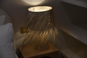 a lamp sitting on a table next to a bed at Amber Apartments in Jávea